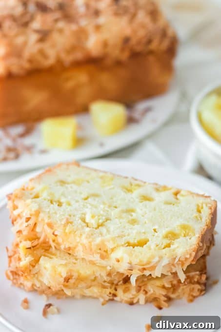 Pineapple Loaf 6 A quick bread made with pineapple and toasted coconut on top, sliced for serving.
