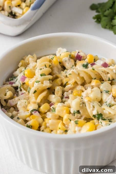 Close-up of a bowl of Mexican Street Corn Pasta Salad with vibrant colors.