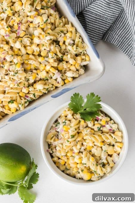 A large bowl of corn pasta salad infused with vibrant Mexican flavors