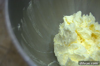 Adding egg yolks to creamed butter and sugar