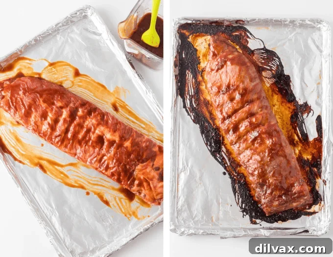 Two racks of Pork Spare Ribs midway through the oven baking process, coated in BBQ sauce.