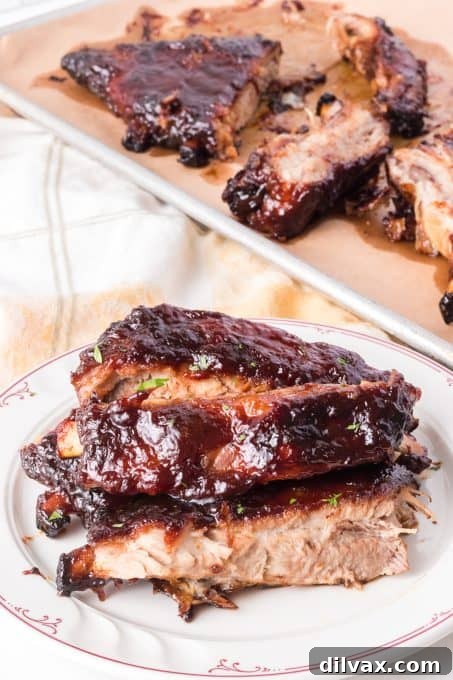 A large platter filled with beautifully arranged, oven-baked pork ribs, ready for a feast.