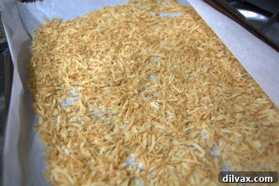 Toasted shredded coconut on a baking sheet