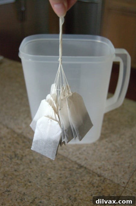 Sweet Southern Brew 5 A delicious and refreshing summertime drink! Close up of tea bags tied together in a pitcher with hot water.