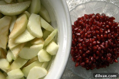 Apple slices and pomegranate seeds being folded together