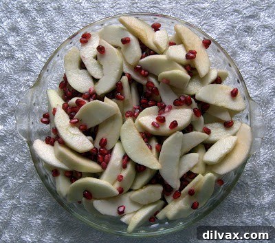 Crumble topping being sprinkled over the fruit filling