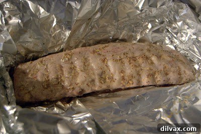 Sweet and Tangy Honey Mustard Ribs 4 Partially cooked ribs, unwrapped from foil after the initial baking phase.