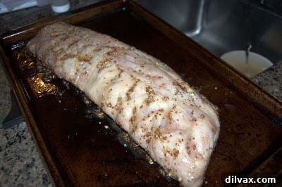 Sweet and Tangy Honey Mustard Ribs 5 Ribs brushed with honey on a baking sheet, preparing for the final bake.