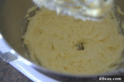 Egg yolks and vanilla extract added to the creamed mixture, ready to be blended.
