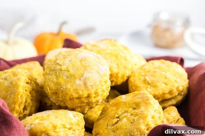 Golden Pumpkin Delights 2 A basket of homemade biscuits made with pumpkin puree, garnished with fall leaves.