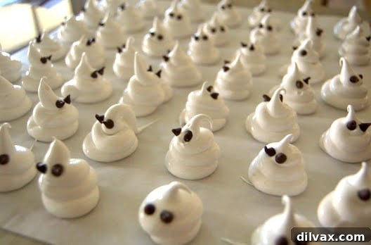 A group of finished Halloween Ghost Meringues on a plate, ready to be served.