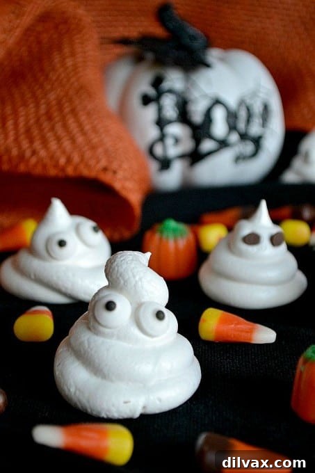 A close-up of a smiling ghost meringue, highlighting its dairy-free and gluten-free qualities.