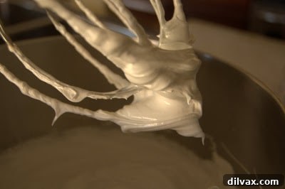 Fully whipped meringue showing stiff and glossy peaks.
