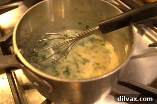 Lemon-caper sauce cooking in a saucepan