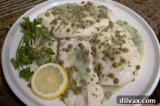 Finished Baked Chicken Piccata with sauce and capers