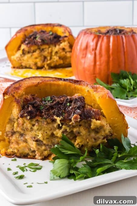 Cross-section view of a stuffed pumpkin, showing the savory cornbread, bacon, and sausage filling.