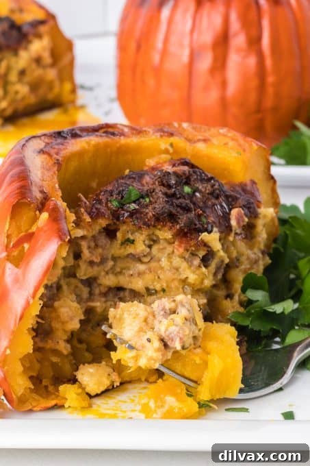 A close-up of a halved stuffed pie pumpkin, emphasizing the hearty, golden-brown filling.