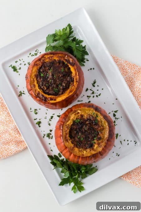 Beautifully roasted small pumpkins filled with a rich and savory cornbread and meat stuffing.