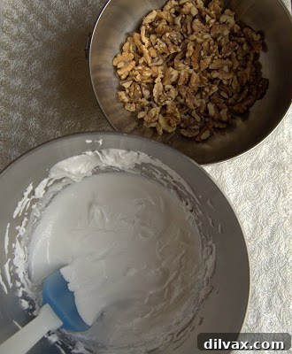 Daily Walnut Bake 19 Egg whites beaten to stiff peaks in a bowl.