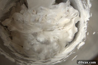 Daily Walnut Bake 20 Walnuts being folded into a glossy meringue mixture.