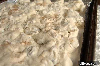 Daily Walnut Bake 22 Baked walnuts sprinkled with cinnamon on a baking sheet.