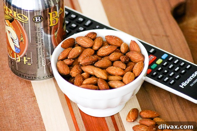 Top view of a bowl of crispy Baked Spiced Almonds seasoned with curry, garlic, paprika, and cayenne.