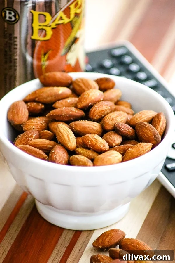 Bowl of savory Baked Spiced Almonds ready for snacking.
