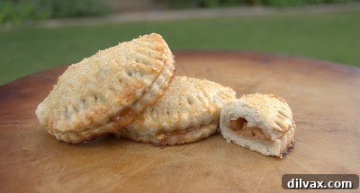 A close-up shot of a baked apple hand pie, showing its flaky crust and tempting golden-brown surface.