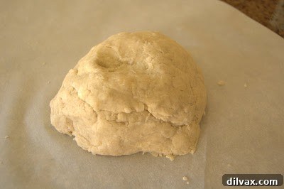 A freshly formed pie dough ball, with a unique pattern that resembles a skull with an eye socket and teeth.