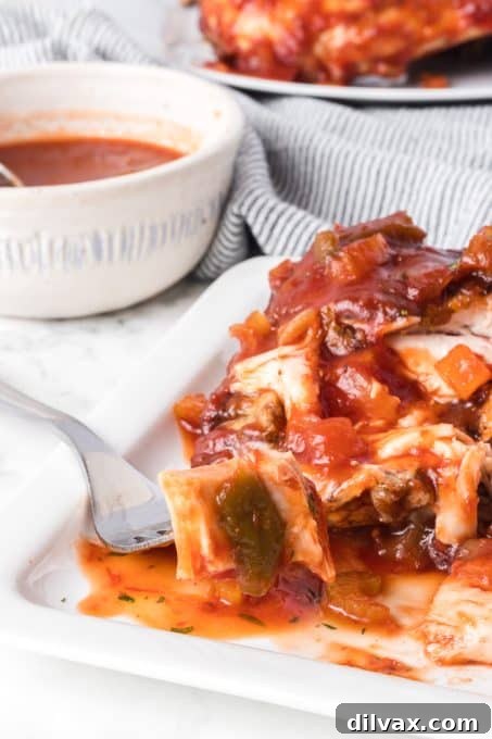 Smoky BBQ Chicken 14 A bite of cooked chicken on the grill basted with homemade barbecue sauce.