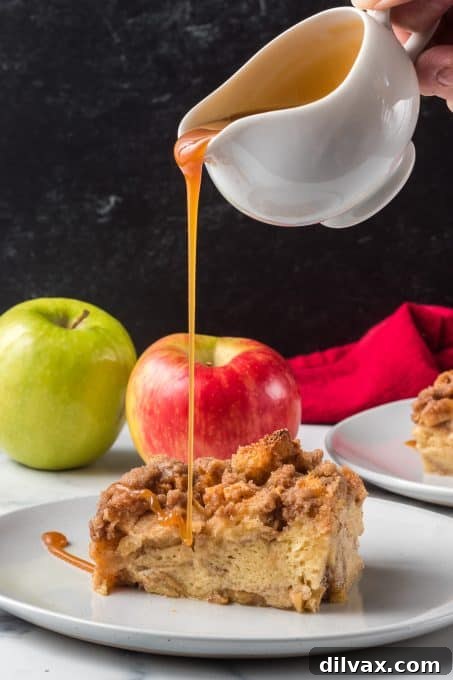Sticky Caramel Apple French Toast Bake 9 A hand drizzling extra caramel sauce over a slice of warm baked apple French toast.
