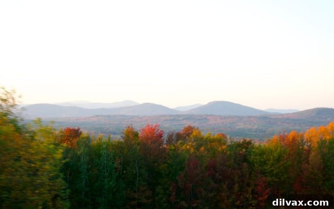 Reflections of vivid fall foliage on a calm New Hampshire lake