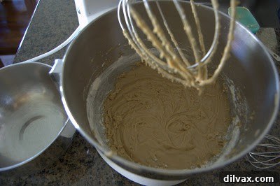 Cookie dough being mixed with crushed Junior Mints, showing the green and white centers.