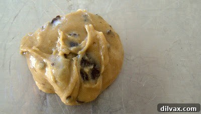 Scoops of Junior Mint cookie dough neatly arranged on a baking sheet, ready for the oven.