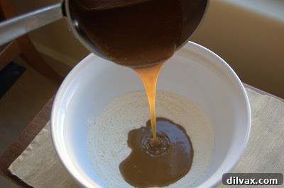 Close-up of the smooth peanut butter batter in a mixing bowl, ready for the next step.