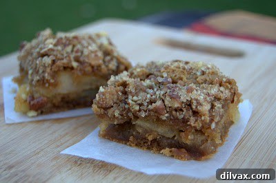 Fully baked Apple Peanut Butter Bars cooling on a wire rack, showing a perfectly golden crust.