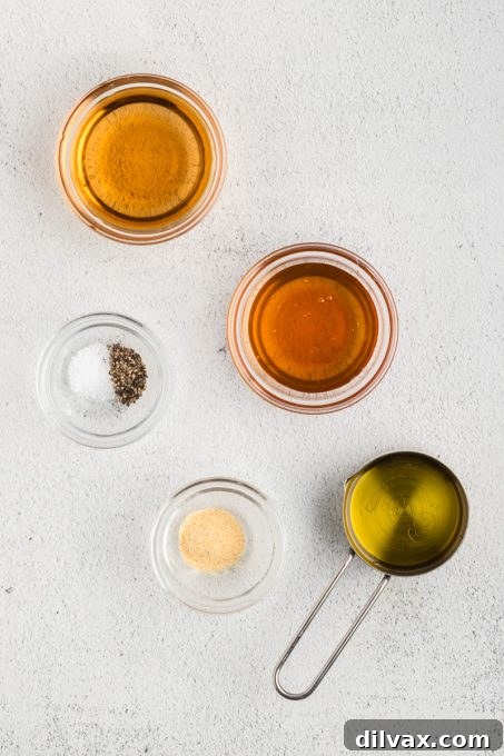 Winter Harvest Bowl 5 Vinaigrette dressing ingredients for a Winter Salad laid out on a table.