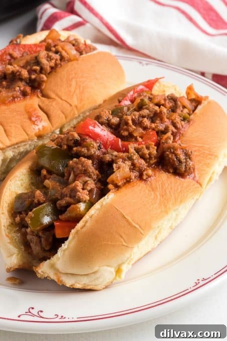 A close-up of a torpedo roll generously filled with a flavorful and spicy meat sauce, akin to a superior Sloppy Joe.