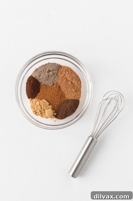 Autumn Spice Blend 5 A small bowl containing the blended Apple Pie Spice, with a spoon for mixing.