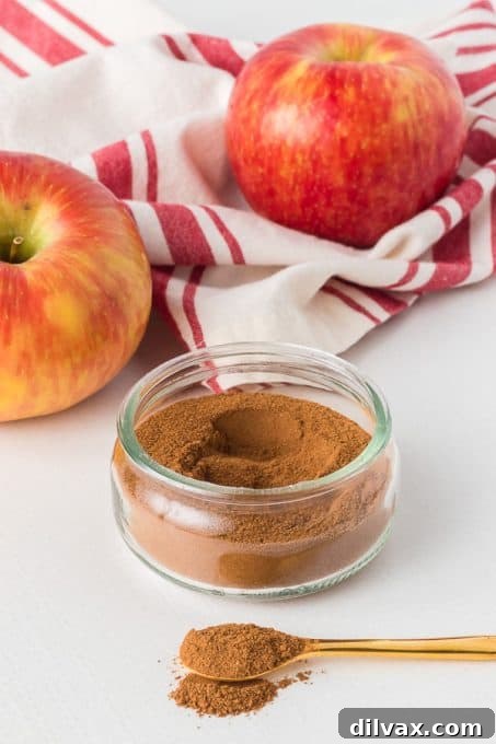 Autumn Spice Blend 8 A wooden spoon scooping homemade Apple Pie Spice from a jar.