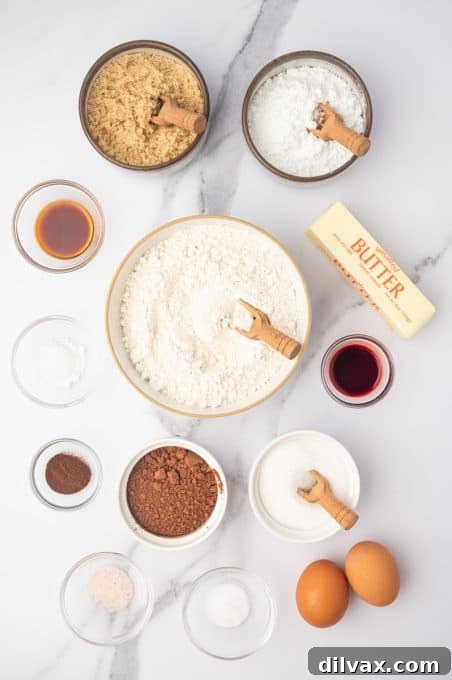 Red Velvet Crinkles 4 A collection of ingredients laid out on a surface, ready for making Red Velvet Crinkle Cookies.