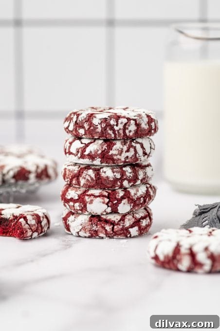 Red Velvet Crinkles 10 A stack of several Red Velvet Crinkle Cookies, showcasing their height and appealing texture.