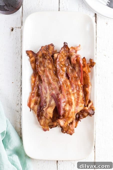 Perfectly Crispy Oven Bacon 8 Crispy bacon on a plate.