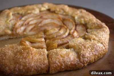 Rustic Cinnamon Pear Tart 17 An overhead view of the Cinnamon Pear Galette on a cutting board, ready to be sliced.