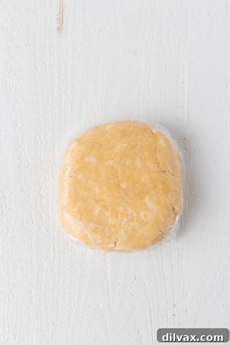 Rustic Cinnamon Pear Tart 6 Galette dough wrapped in plastic wrap and ready for chilling in the refrigerator.