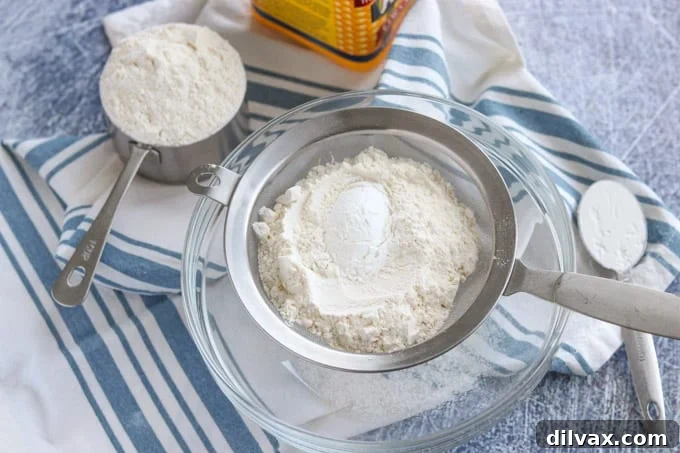 Sifting all-purpose flour and cornstarch together to create homemade cake flour substitute for light and airy cakes.