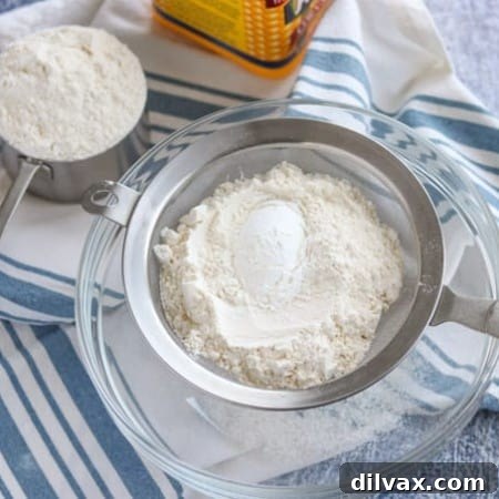Sifting all-purpose flour and cornstarch together to create a homemade cake flour substitute for baking.