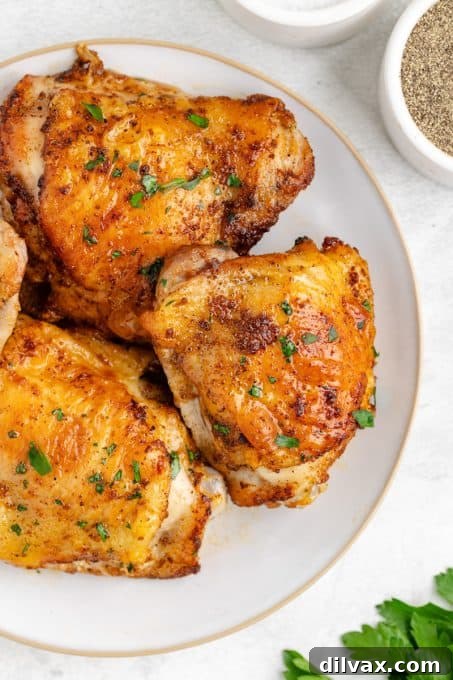 Crispy Air Fryer Chicken Thighs 9 Easy cooked Chicken Thighs on a wooden board.