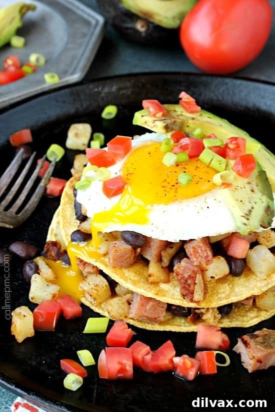 Stacked Huevos Rancheros Breakfast with sunny-side-up eggs