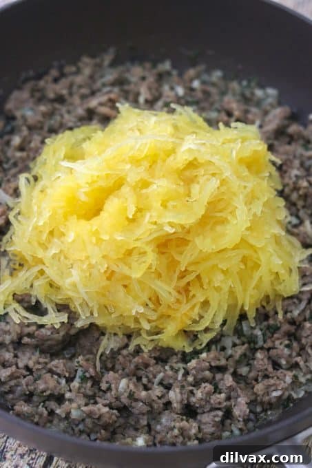 Hearty Sausage Spaghetti Squash Bake 7 Spaghetti squash on top of ground sausage.